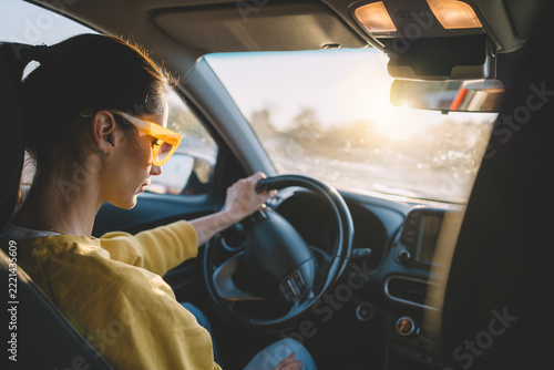 Woman driving car through the city