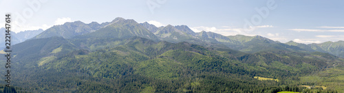 Wide Panorama of Alpine Mountain Range and Green Hills