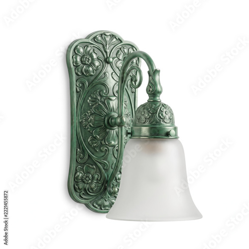Elegant green ornate wall sconce features frosted glass
