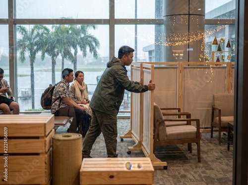 Tropical Airport Terminal Staff Preparing for Rainy Season Holiday Operations