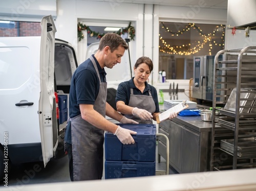 Volunteers aiding holiday food surplus redistribution in kitchen