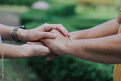 Close Up of Hands Offering Care and Support, Family Love and Compassion Outdoors