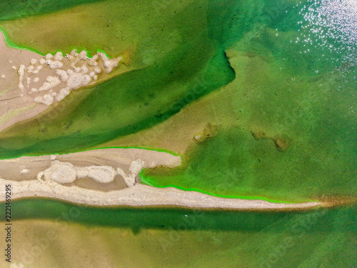 Aerial View of Green Water Patterns and Exposed Sandbar in a Reservoir