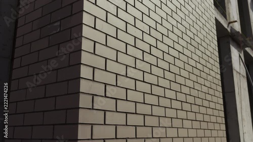 Close up of brick building facade corner with sunlight and shadow
