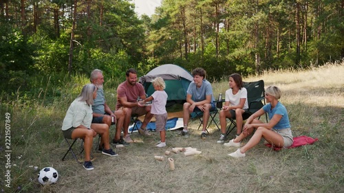 Family relaxing and spending time together at campsite.