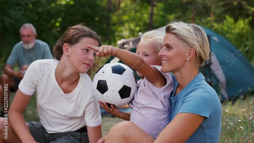Family relaxing and spending time together at campsite.