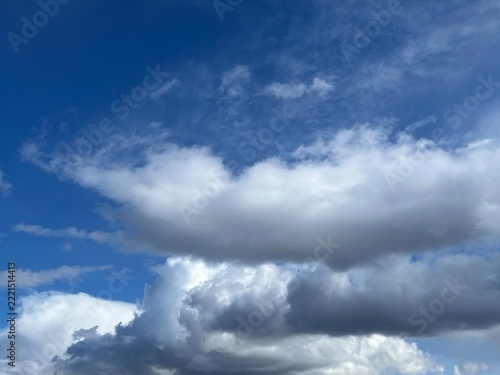 Dramatic white and grey clouds against a deep blue sky