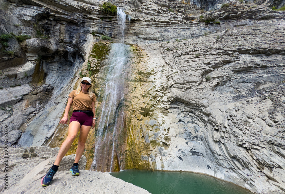 Fototapeta premium Relaxing woman by a Waterfall, Cascada del Sorrosal