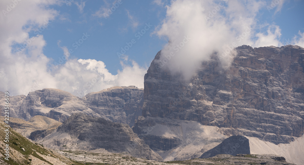 Fototapeta premium Mountain landscape panorama Tre Cime Mount against a blue summer background. 