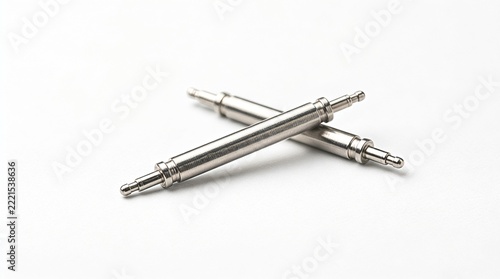 Pair of stainless steel watch band spring bars crossed isolated on a white background.   