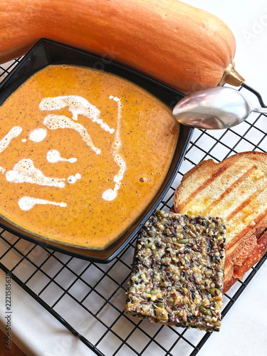 Homemade Pumpkin Soup Served with Toast and Seed Cracker