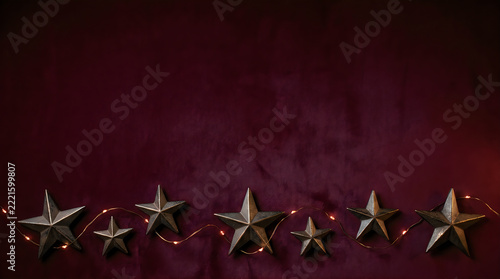 Burgundy velvet Christmas background with silver stars, dark festive holiday card copy space, elegant luxury velvet banner