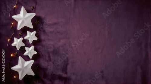 Elegant Christmas background with white star ornaments on dark purple velvet texture, festive holiday background with copy space for banner design