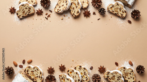 German Stollen Fruit Bread and Pinecone Border Layout on Solid Warm Beige Background