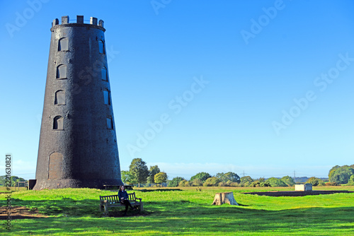 Lady sat beneath the Black Mill, in Beverely, East Riding of Yorkshire, England.