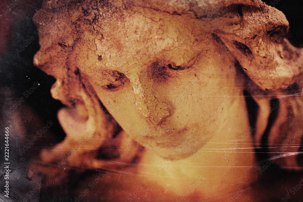Fototapeta premium Close-up of a sorrowful angel statue in warm light, symbolizing tenderness, compassion, grief and eternal love.