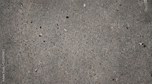 Close up of a textured gray stone wall with subtle color variations