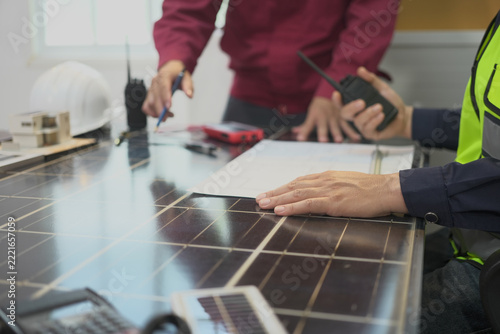 Solar panel inspection, engineer, blueprint, radio and renewable energy planning at indoor workbench