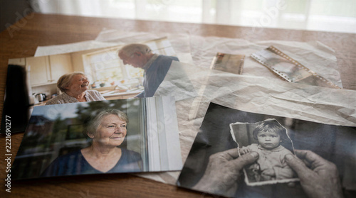 Elderly Woman Holding Old Family Photographs Reflecting On Memories Alzheimer Disease Caregiver Support Concept Senior Nostalgia Mental Health Decline Emotional Moments Past Life Reflection Grief Loss