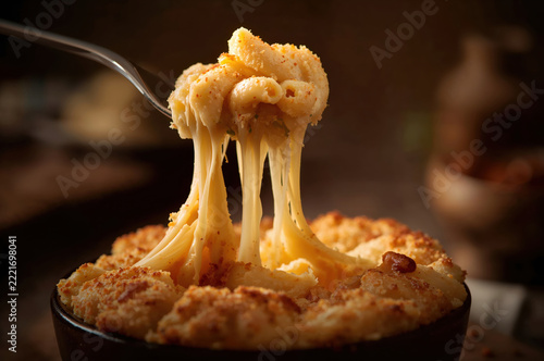 Golden baked mac and cheese with creamy texture and stretchy cheese pull