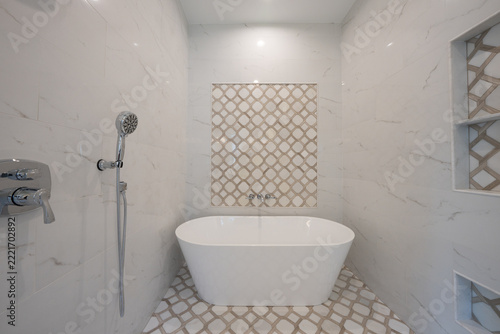 Bathroom shower has been updated with new ceramic tile and fixtures