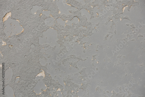 Abstract textured background of grey peeling paint on a surface