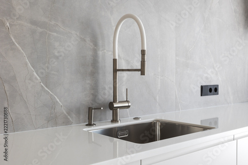 kitchen faucet on a stylish metal sink