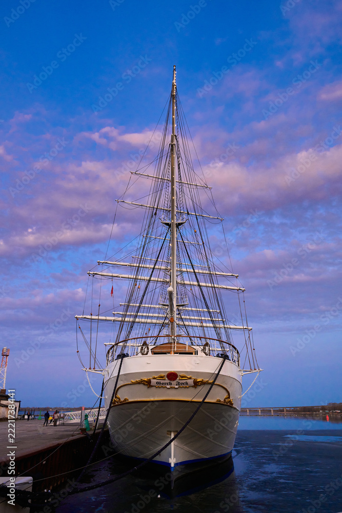 Fototapeta premium Gorch Fock Tall Ship Docked at Port with Dramatic Sunset Sky