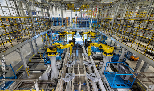 Robots in a car plant. Robotic arms in a car plant