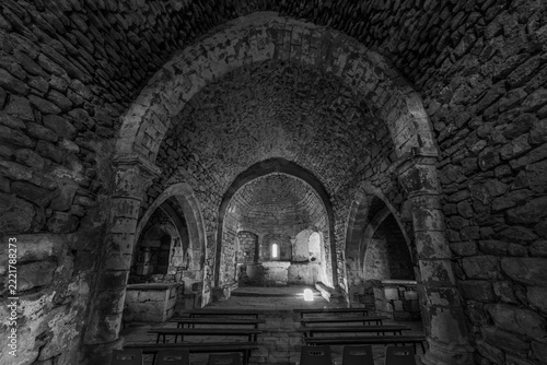 Obraz na plátně Old stone crypt interior with light filtering