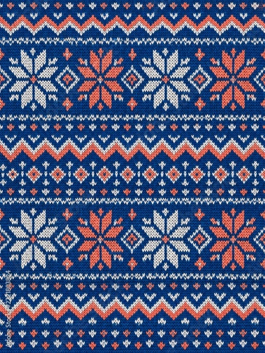 Blue knitted winter pattern with coral snowflakes and geometric stitch bands