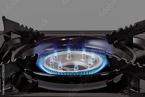 Black portable single burner gas stove with automatic ignition. Compact cooker for camping and outdoor cooking.