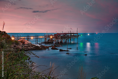 Abruzzo, Italy: Landscape of the Adriatic Sea coast at dusk with an old trabocco fishing hut, a traditional Mediterranean wooden pilework