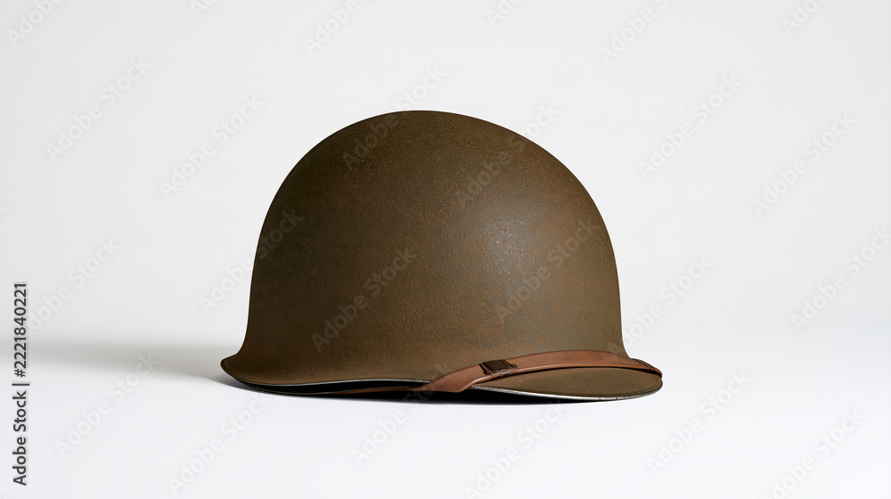 Naklejka premium Antique military helmet displayed in a close-up studio shot against a pure white background, historical artifact concept, with copy space