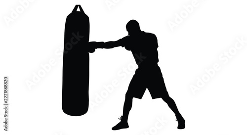 Boxer punching heavy bag in black silhouette