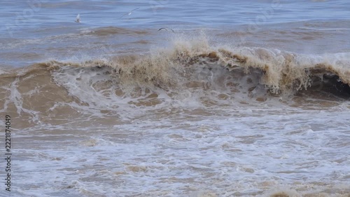 Powerful Brown Sea Waves During a Storm. Rough Muddy Sea Waves Surging in Stormy Weather. Turbulent Brown Ocean Water with Strong Waves.