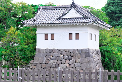 Fotografie Traditional Japanese castle watchtower building on stone wall