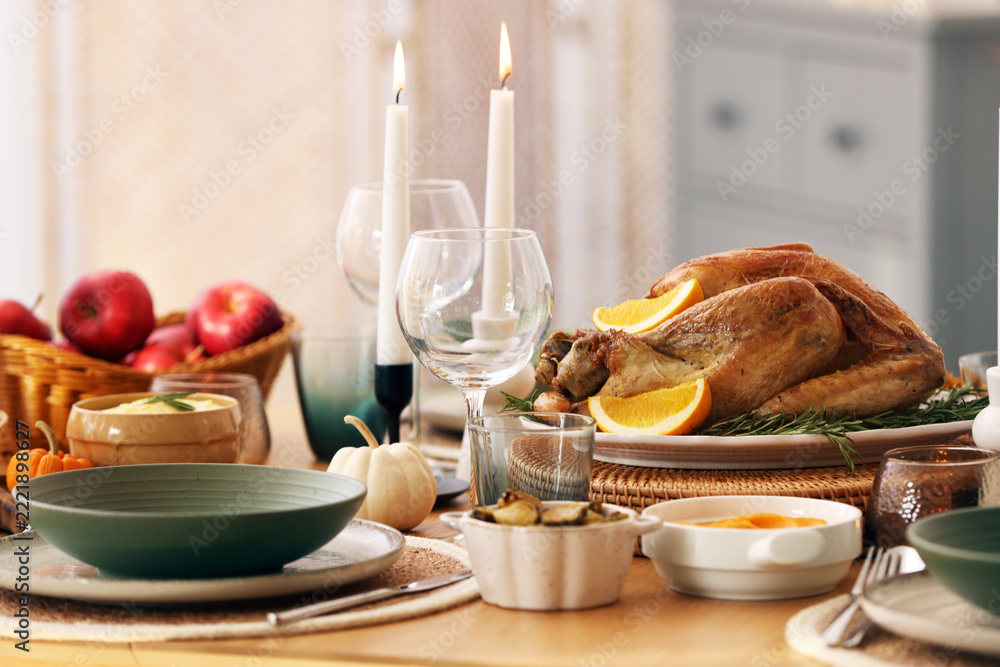 Fototapeta premium Happy Thanksgiving day. Festive dinner with delicious food and burning candles on wooden table indoors, closeup