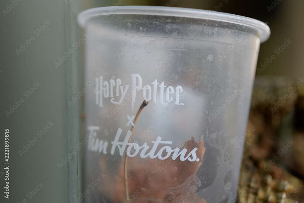 Naklejka premium macro of discarded and grungy plastic beverage cup featuring Harry Potter x Tim Hortons branding in Toronto