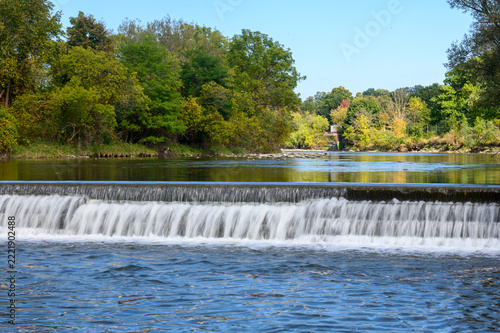 Photography Water flows over a concrete weir in a river