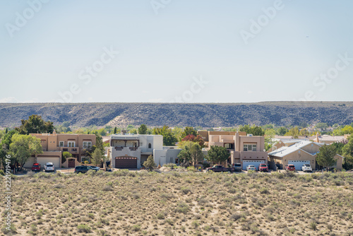 Suburban Houses and Desert Landscape with Distant Volcanic Hills