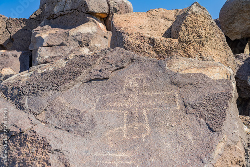 Ancient petroglyph carved into dark volcanic rock