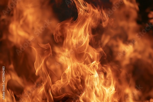 Vibrant dancing flames and hot glowing embers creating abstract fire background texture