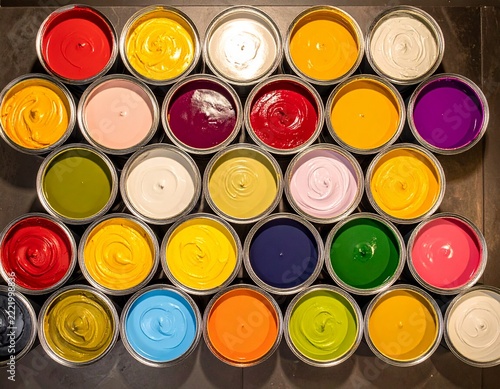 Overhead view of open paint cans showing a rich palette of vibrant colors