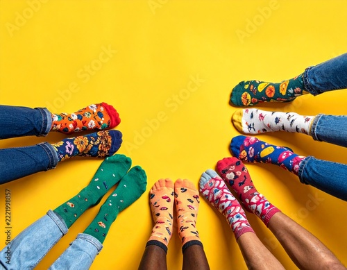 Diverse feet forming a circle, wearing colorful patterned socks, symbolizing individual