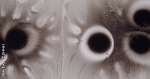 Water paint. Fluid splash. Defocused black white bubbles wet paper pigment texture spreading on abstract creative art background.