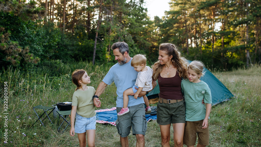 Fototapeta premium Happy family spending time together during summer camping trip.