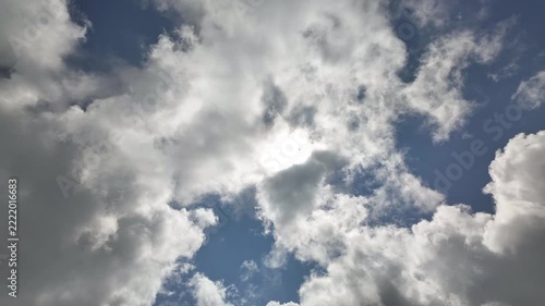 Timelapse of bright sunny sky with billowy white clouds floating in atmosphere