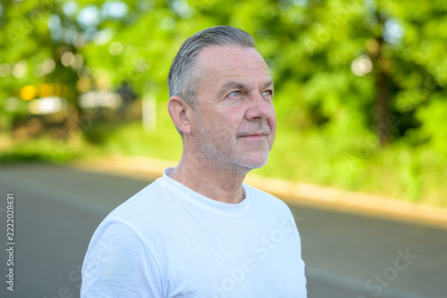 Confident mature man looking upward outdoors