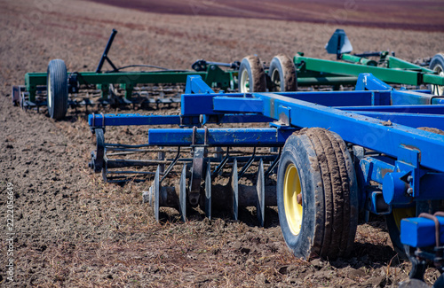 Fotografie Harrow machinery prepares plowed field soil